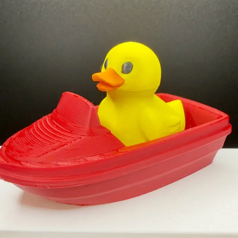 Yellow duck captain in a 3D printed speedboat