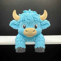Blue Highland cow monitor buddy screen sitter